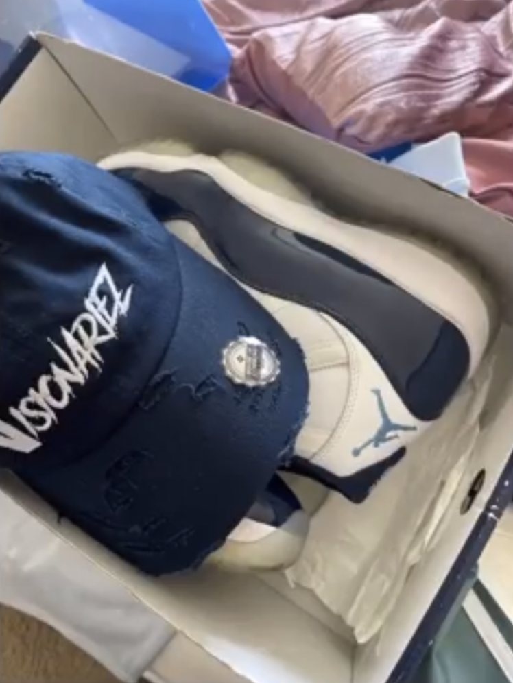 A Nike Air Jordan sneaker, a navy blue cap with white writing The Visionariez',