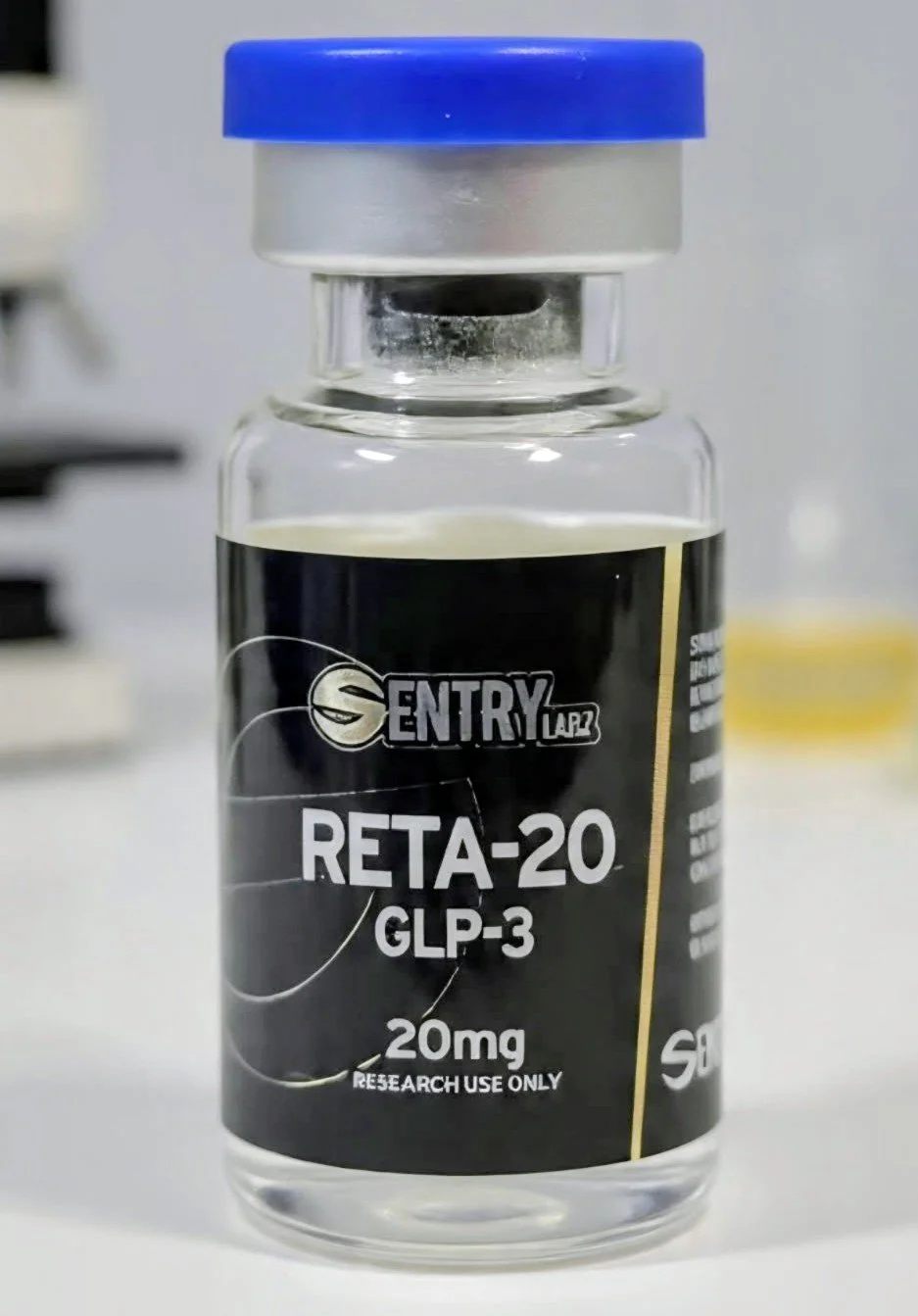A small glass vial labeled 'ATL PEPTIDES' with a blue cap, containing a research chemical for laboratory use, not for human consumption.
