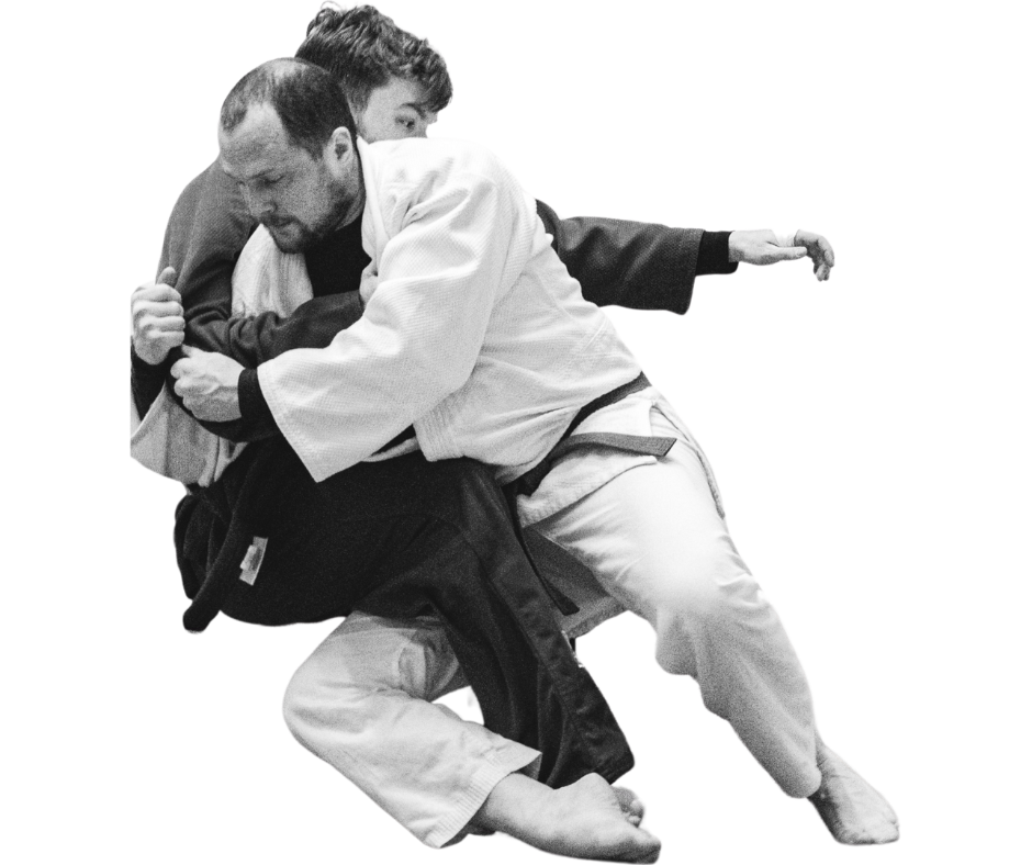 Two men practicing Brazilian Jiu-Jitsu, one in a white gi and the other in a black gi, engaged in a grappling technique on the mat.
