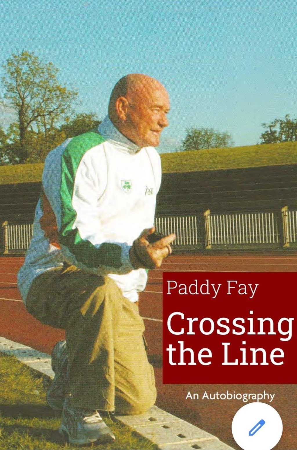 Book cover of 'Crossing the Line' by Paddy Fay, featuring a man in a white and green sports jacket kneeling on a running track, holding a phone, with trees and a fence in the background.