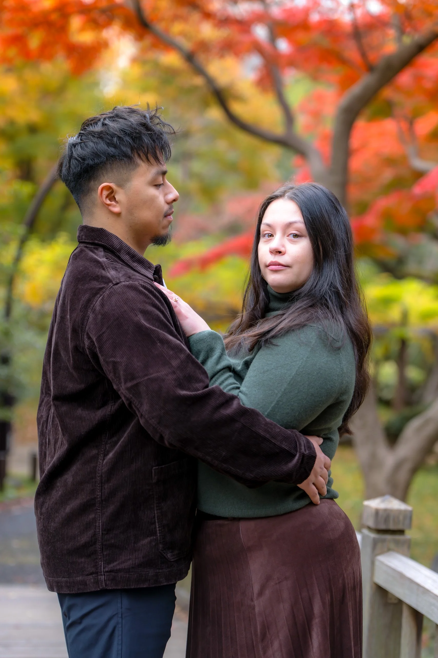 NEwly engaged couple in Tokyo with autumn trees around them