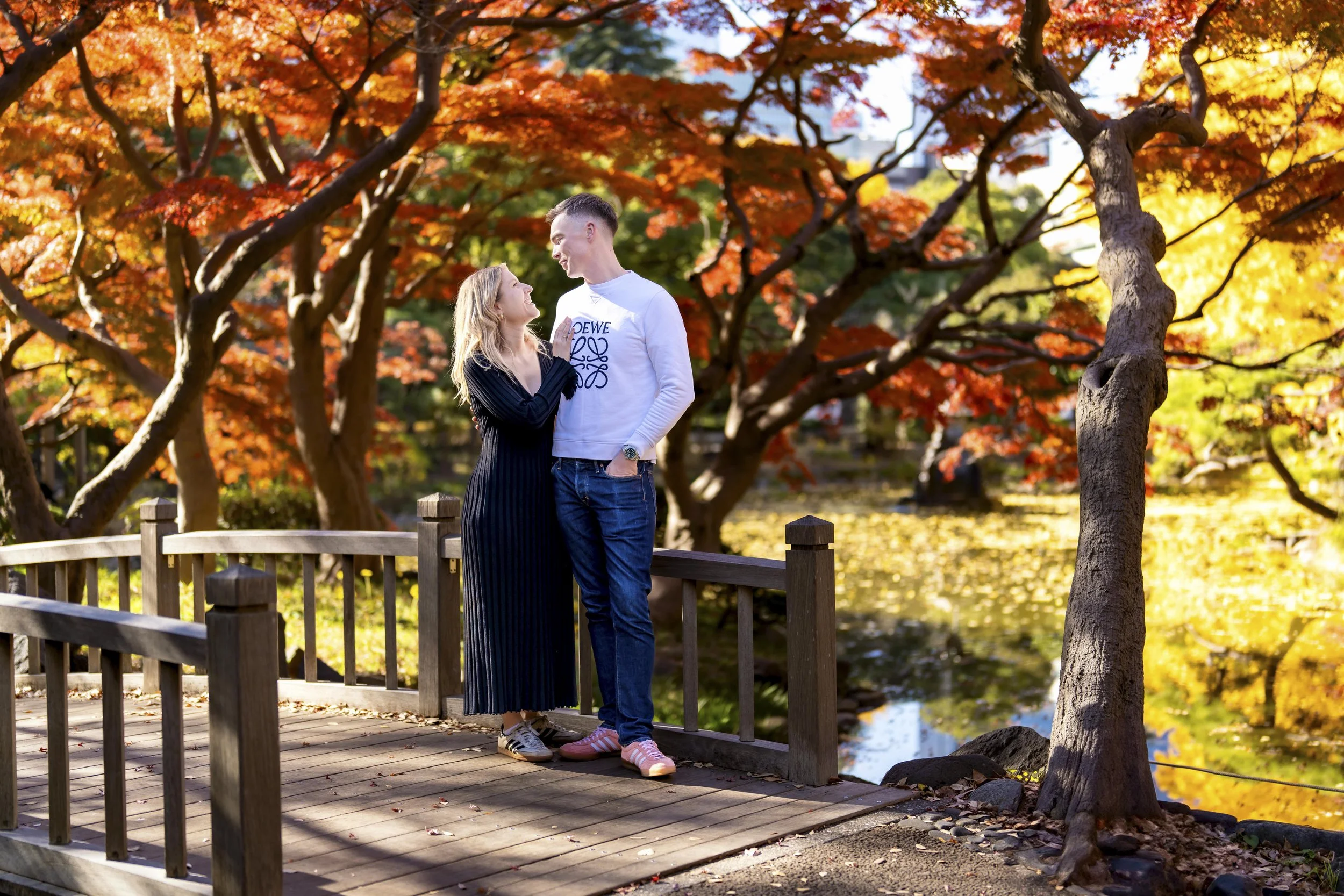 Couple wearing neutral autumn outfits during a photoshoot in Japan