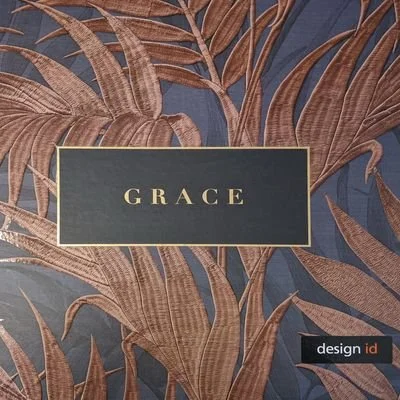A dark blue background with large, brown, leafy tropical plant patterns. In the center, a rectangular label with a black background and gold border displays the word 'GRACE' in gold letters. In the bottom right corner, a small black label with white and red text reads 'design.id'.