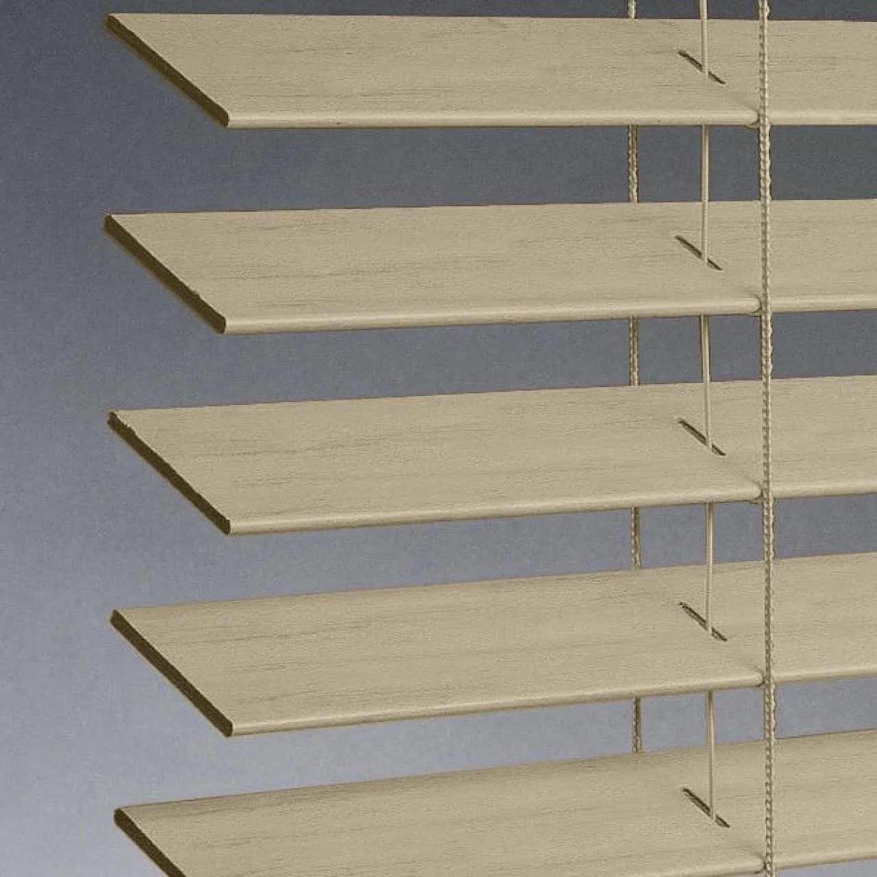 Close-up of horizontal beige window blinds against a blue wall.