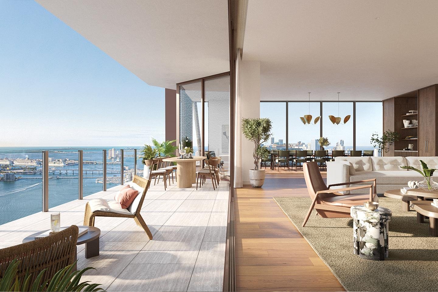 Living room and balcony with city and water view in high-rise apartment