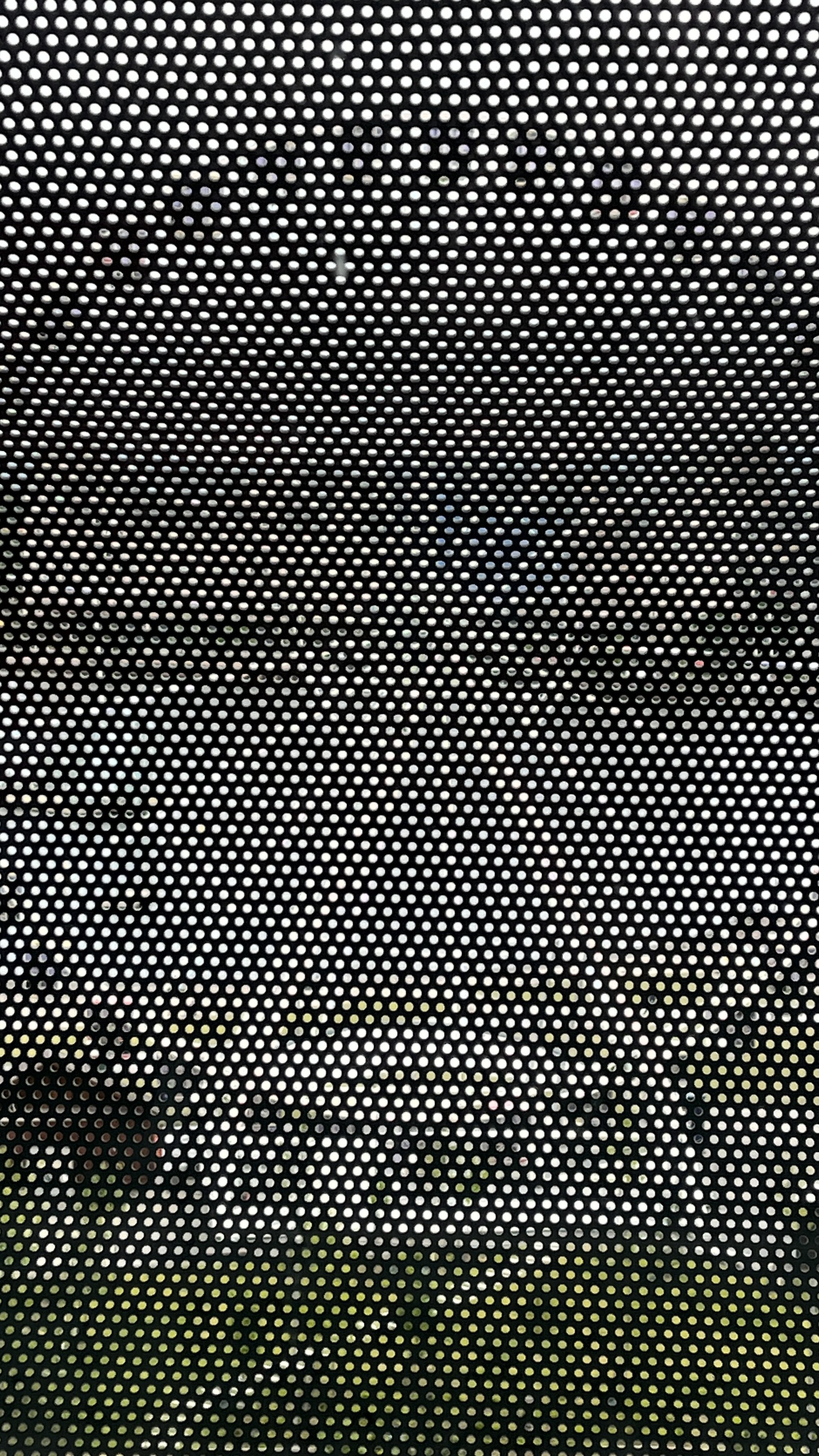 Ferris wheel through the Munch museum’s mesh outer windows.