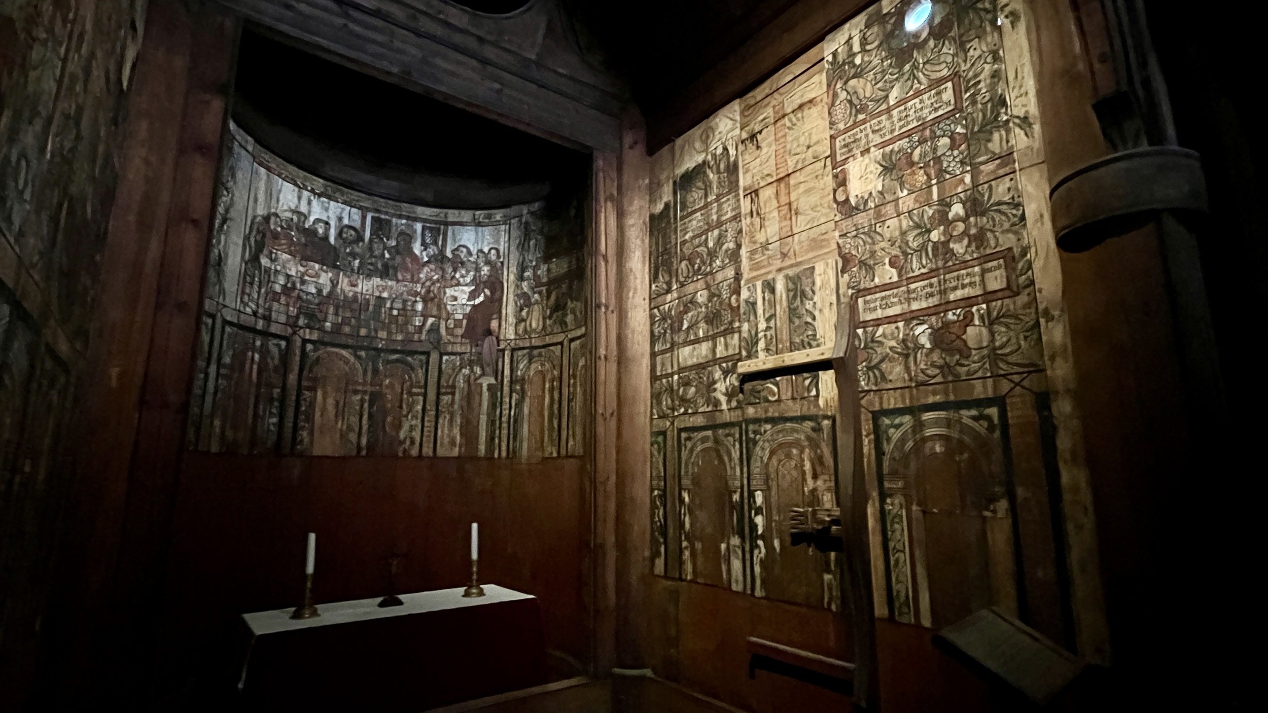 The church’s interior was dark and dramatic, covered in religious imagery.