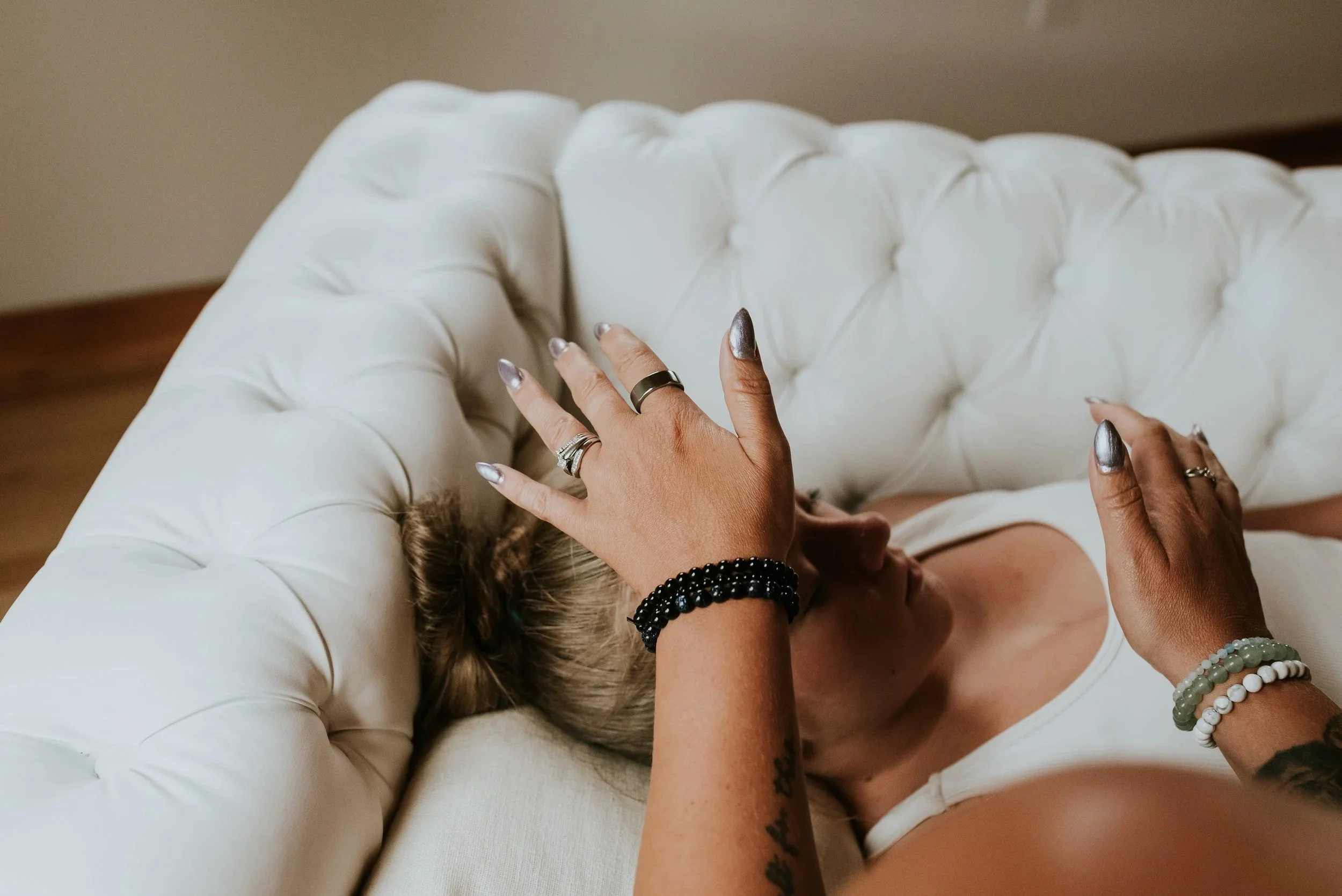 Woman receiving Reiki over her Third Eye and Throat Chakras