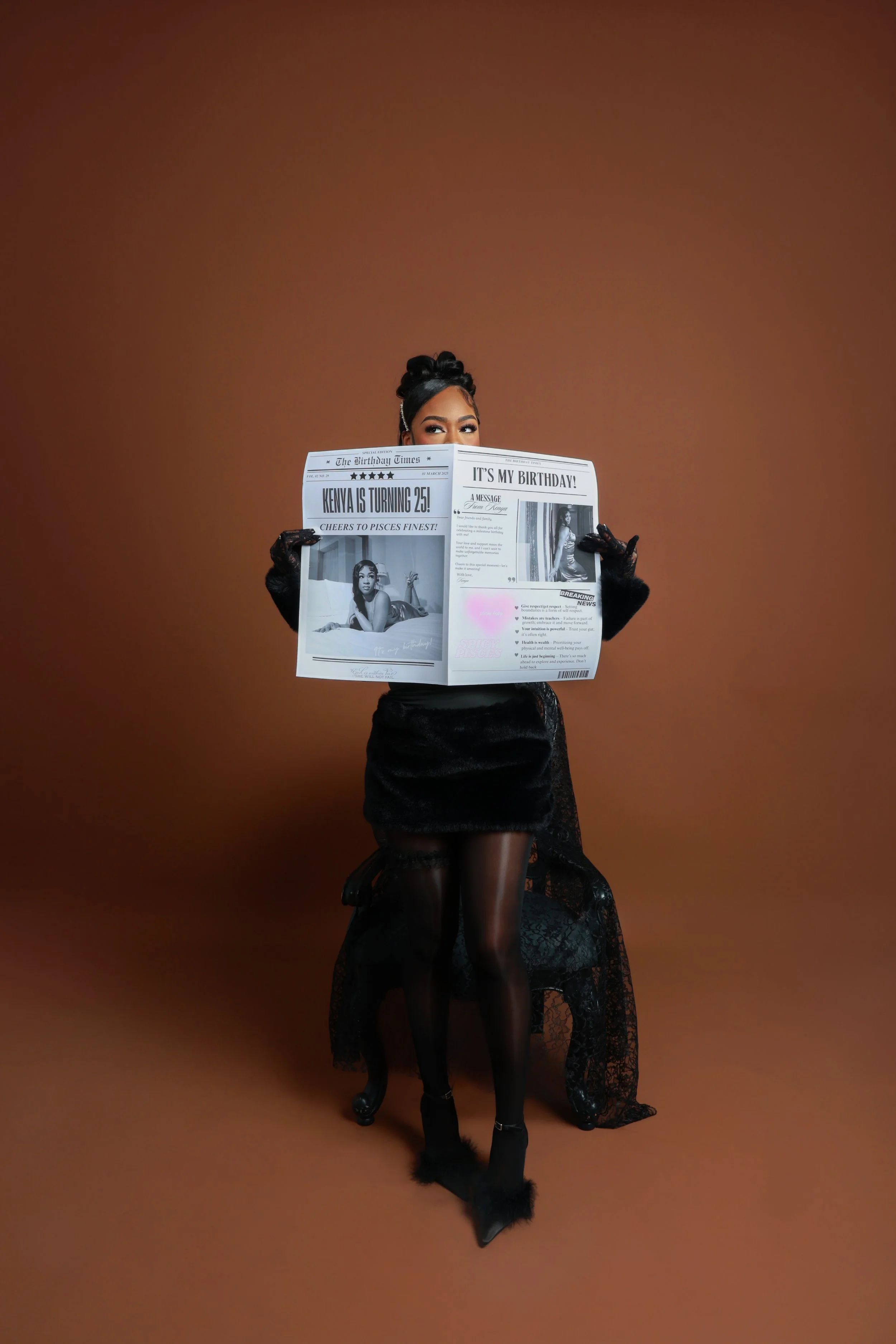Woman in black lace dress and black gloves reading a newspaper against a brown background.