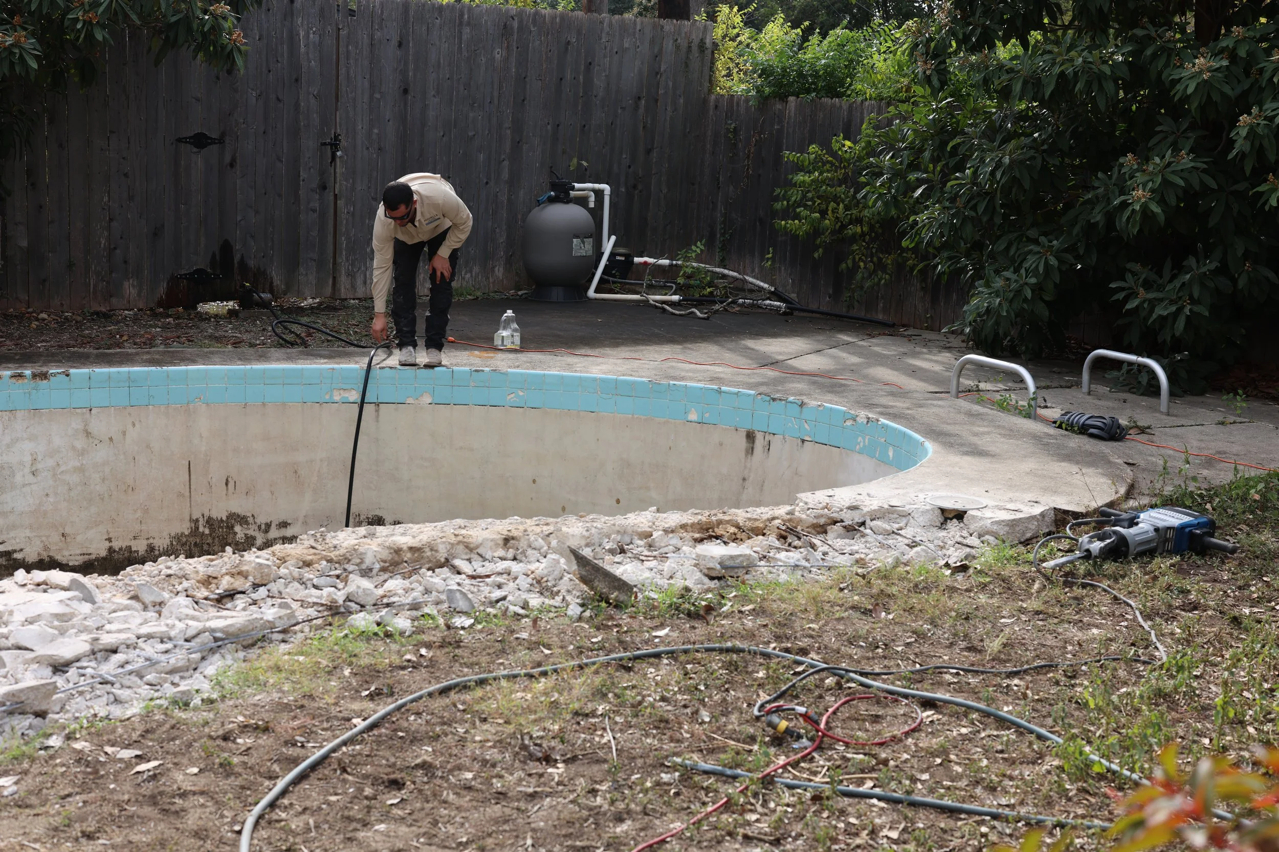 Avanelle Homes filling in a pool in Alamo Heights, TX before the house is listed for sale.