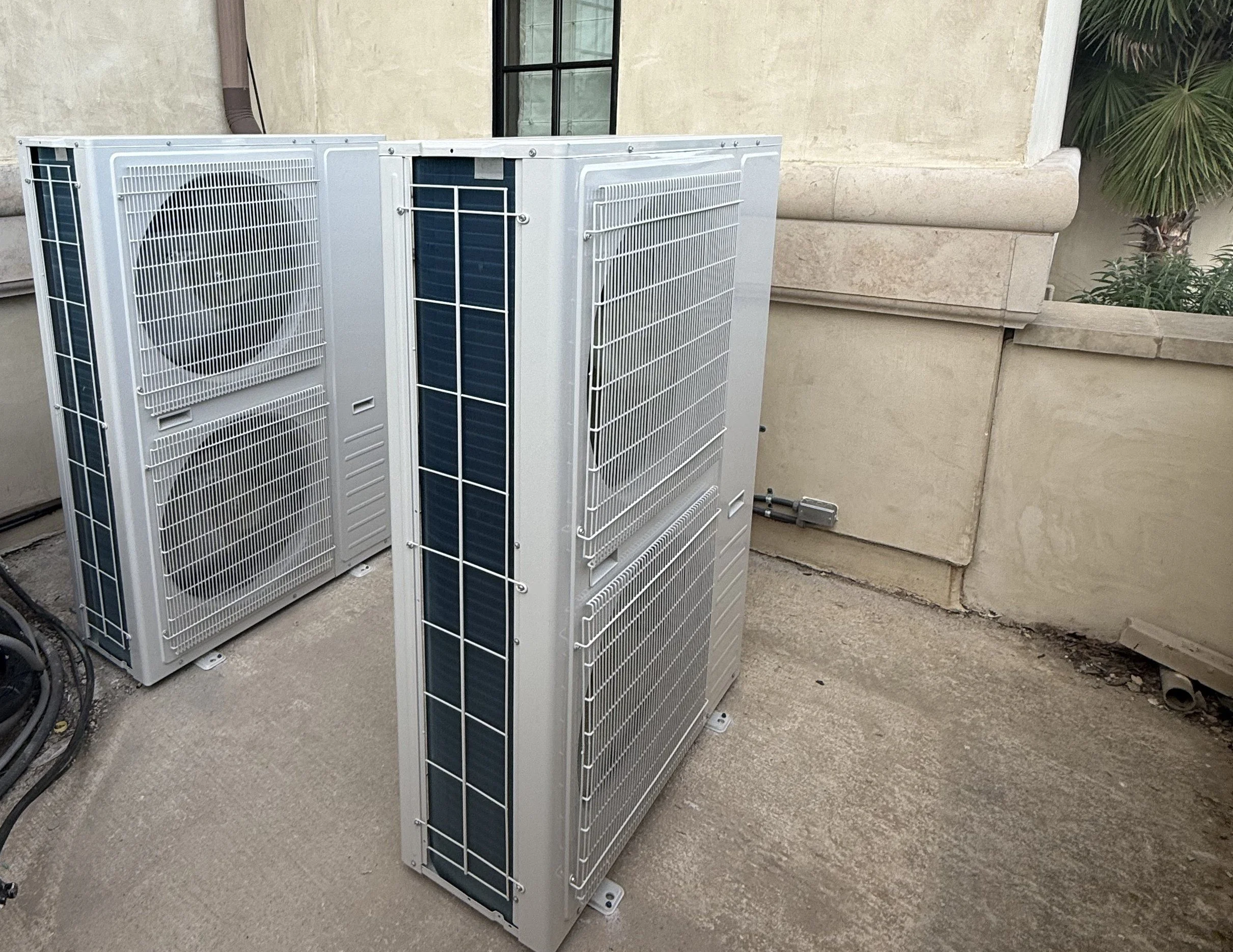 Three newly installed high efficiency side discharge HVAC units on a high end home.