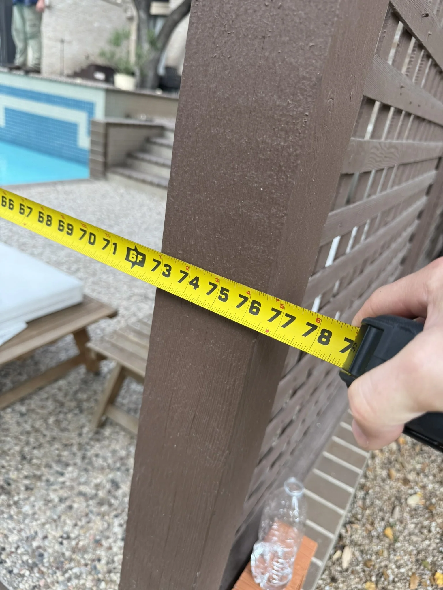 Avanelle Homes taking a measurement for a backyard cabana rebuild in San Antonio, TX.