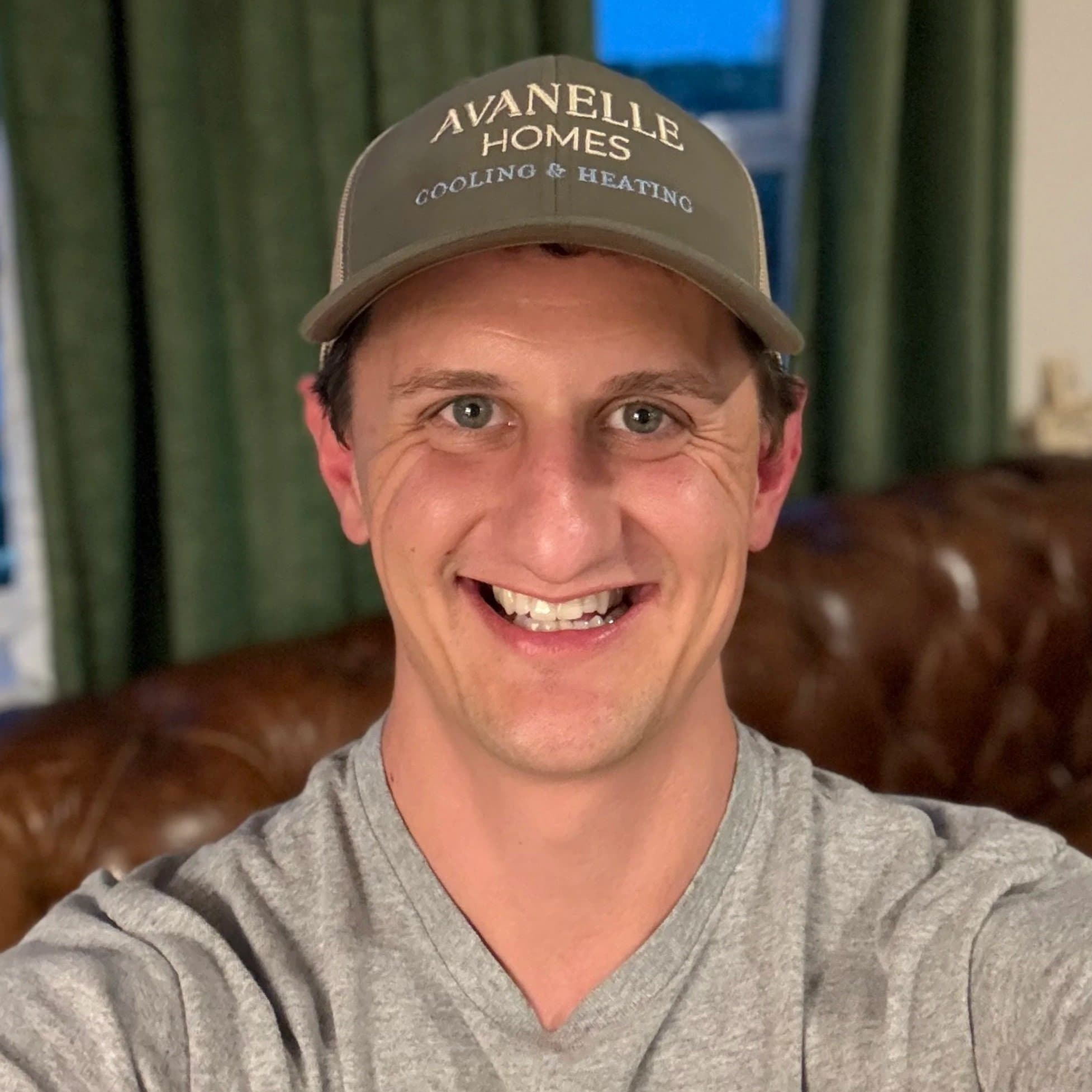 Michael is the owner of Avanelle Homes. He is wearing an "Avanelle Homes Cooling & Heating" baseball hat. Avanelle Homes also has Avanelle Home Renovation as a line of business.