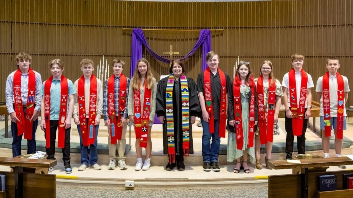 Children's group with Reverend Jeanine standing on stage.