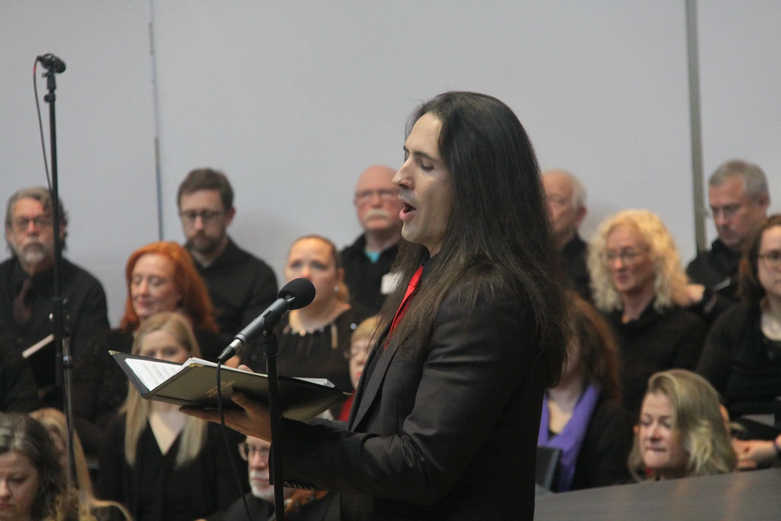 Sanctuary Choir Director Derek B. singing at holiday event.
