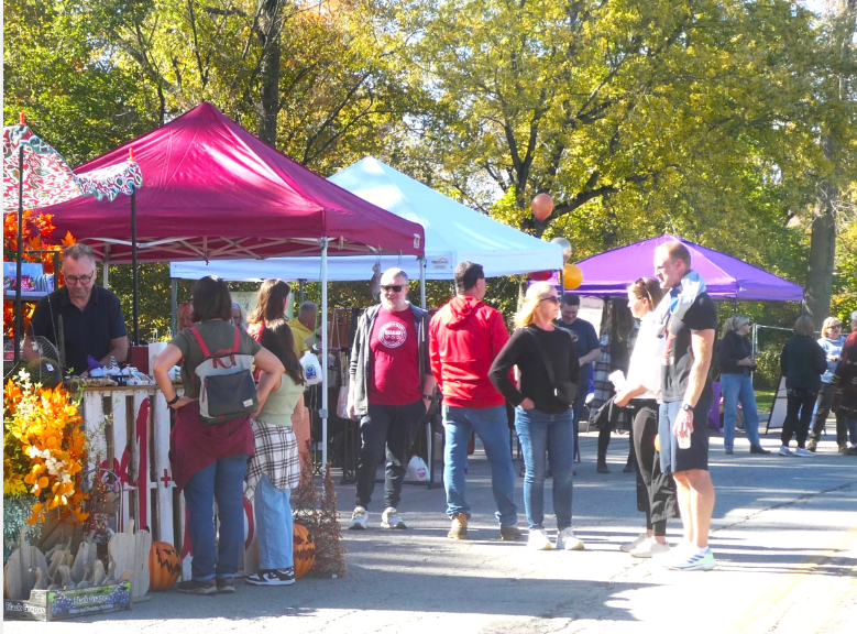 Neighbors mingling in front of vendor booths at the 2024 Millersville Fall Festival