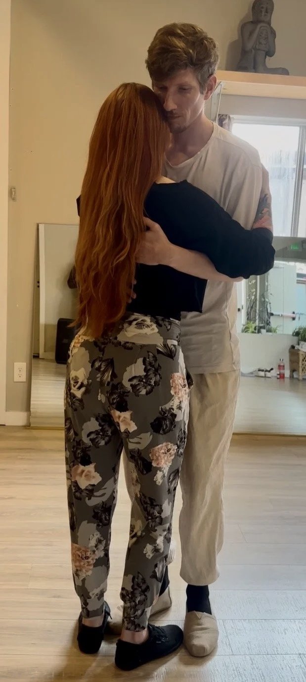 A teacher and a student are dancing in a studio for a private dance lesson. The teacher is teaching the student how to dance Kizomba and Bachata in Spokane, Washington.