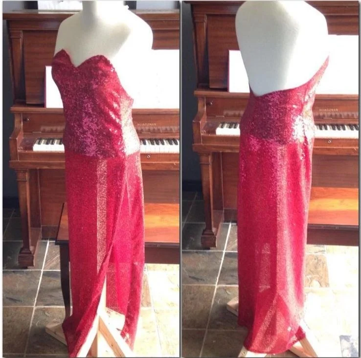 Red strapless sequin evening gown displayed on a mannequin in front of a wooden piano.