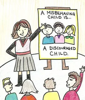A woman pointing to a poster that says 'A misbehaving child is... a discouraged child.' The poster features illustrations of three children, one with hands on hips and another with a sad face, in a classroom setting.