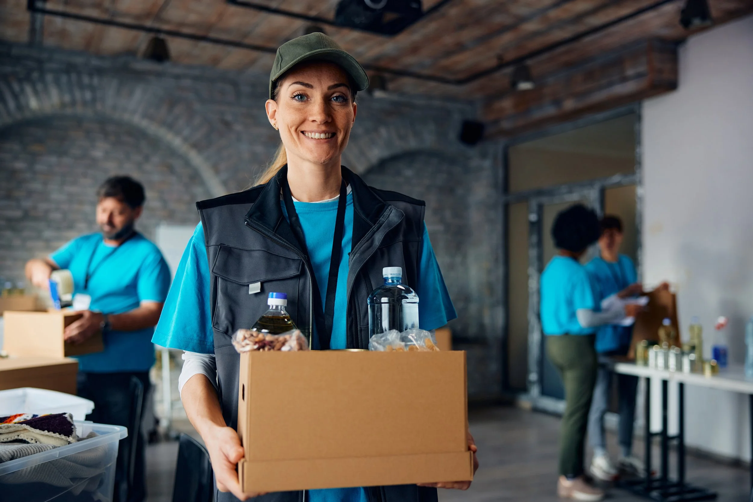 happy-female-charity-worker-with-donation-box-at-f-2024-12-13-18-30-24-utc.jpg