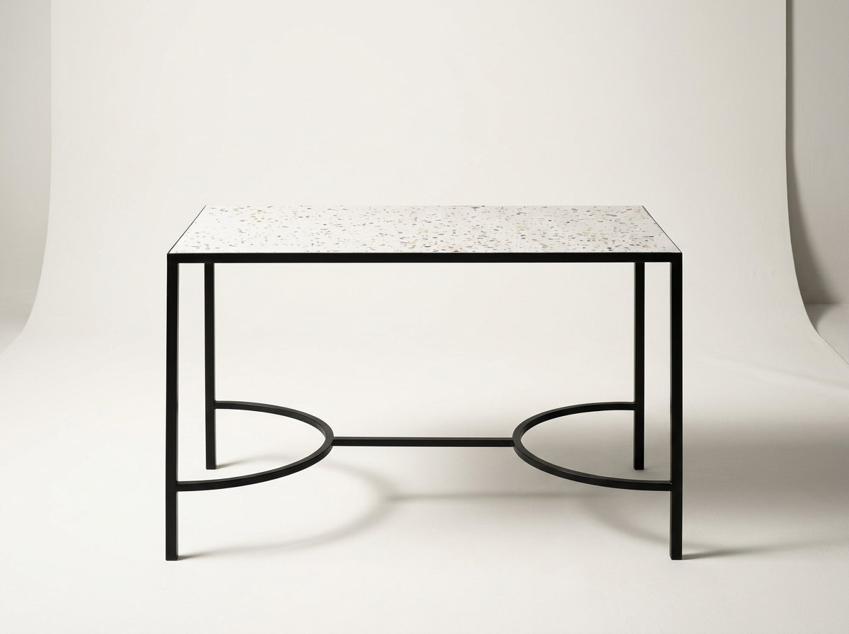 Modern black metal and terrazzo top table on a plain white background.