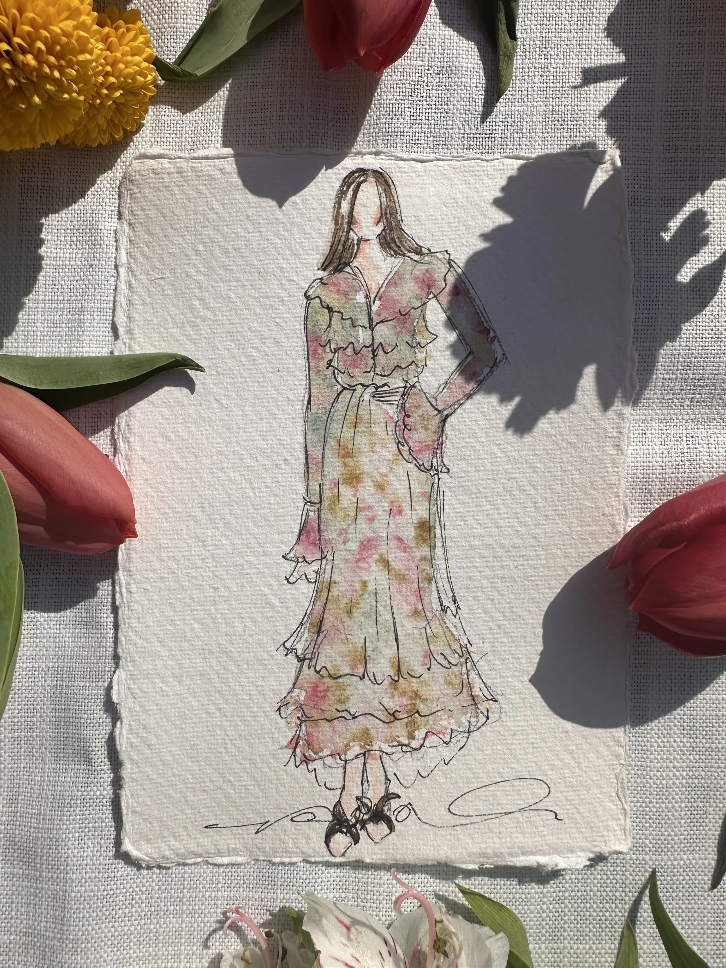 A watercolor sketch of a woman wearing a floral dress with ruffles and a cinched waist, standing with one hand on her hip, surrounded by flowers.