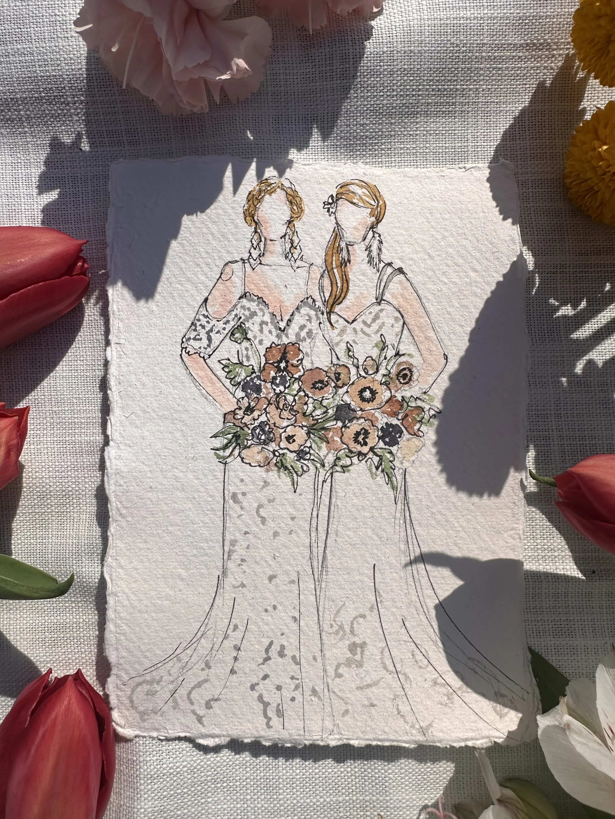 A watercolor sketch of two women in wedding dresses holding a bouquet of flowers, surrounded by pink, red, white, and yellow flowers.