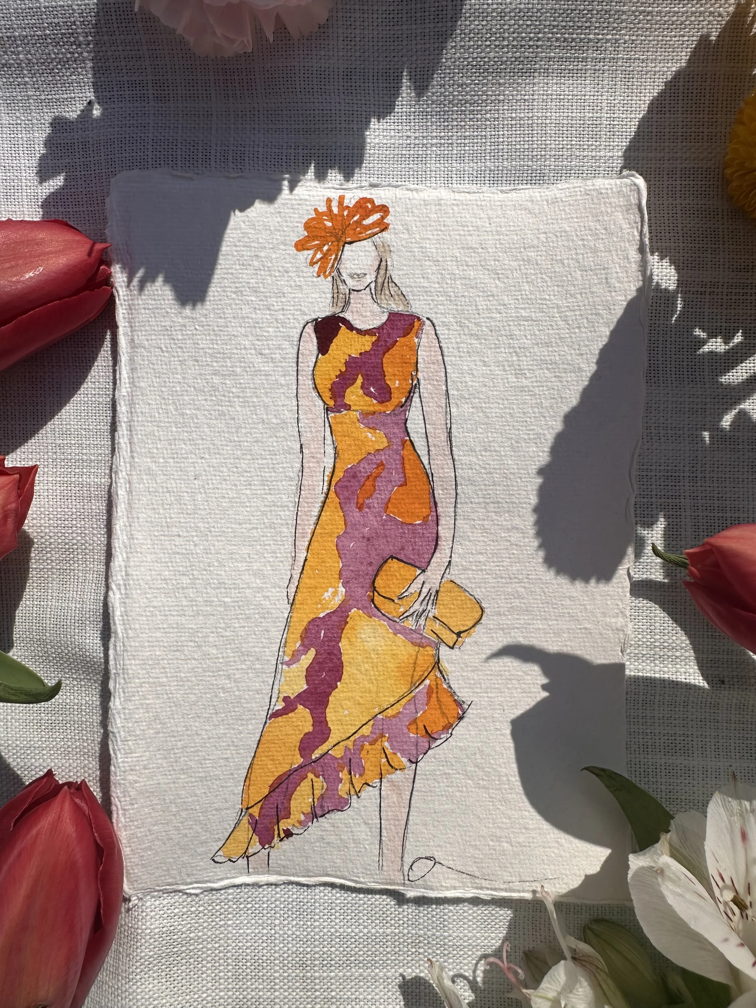 A fashion illustration of a woman wearing a colorful, patterned dress with orange, purple, and yellow hues, holding a yellow clutch, surrounded by flowers and shadows.