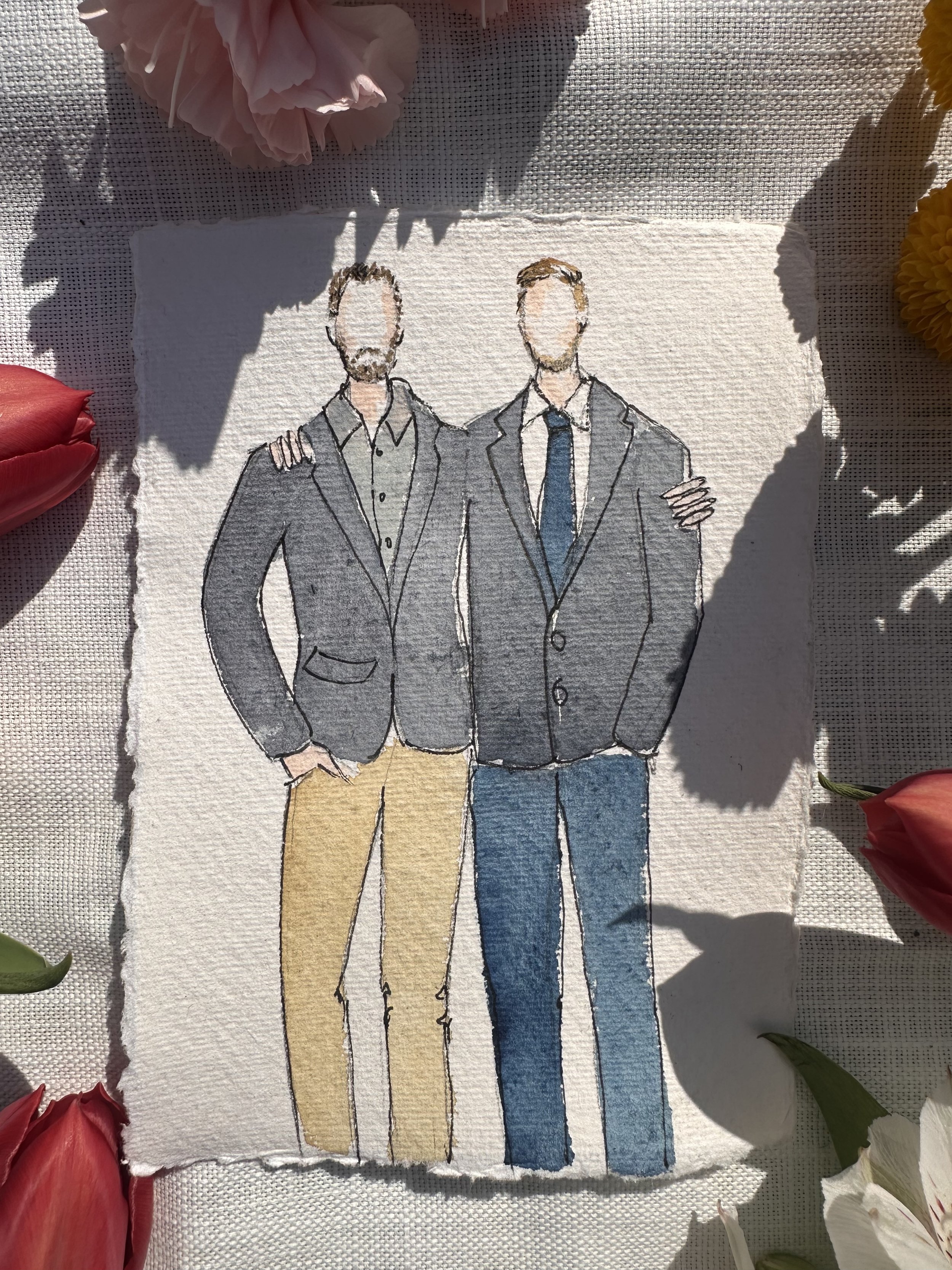 A watercolor illustration of two men wearing suits, with their arms around each other's shoulders, on textured paper surrounded by pink, red, and yellow flowers.
