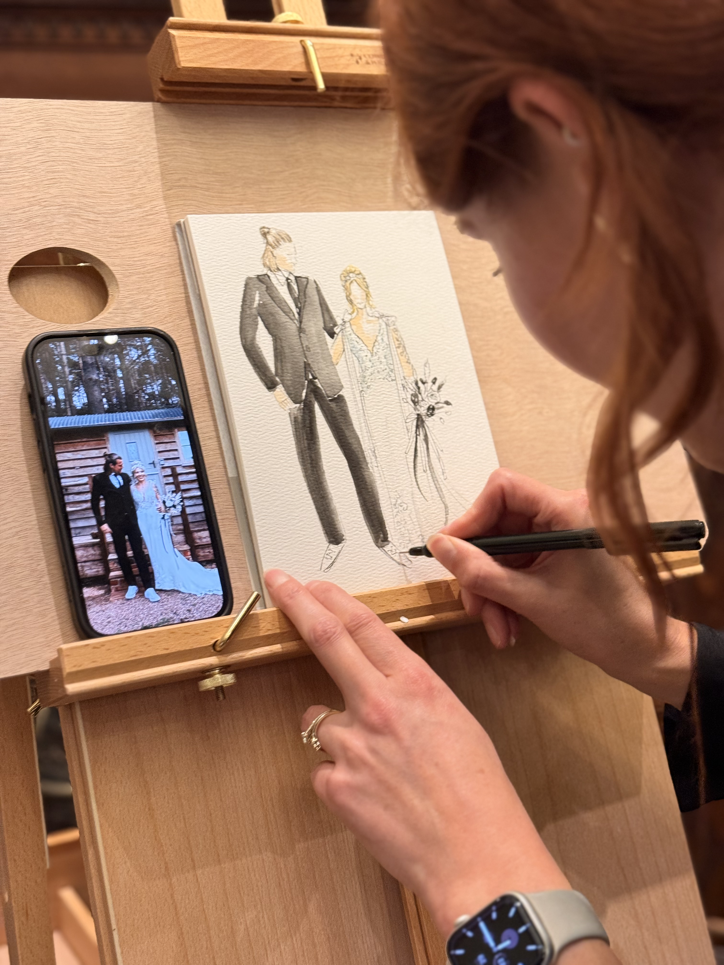 Illustrating a bride and groom live in front of guests.