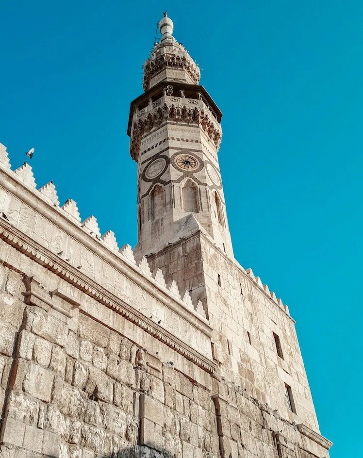 The courtyard of the Umayyad Mosque is surrounded by a colonnaded portico that enhances its grandeur, while three minarets punctuate the skyline, each with its unique history and design elements. The mosque's most famous minaret is the Minaret of the
