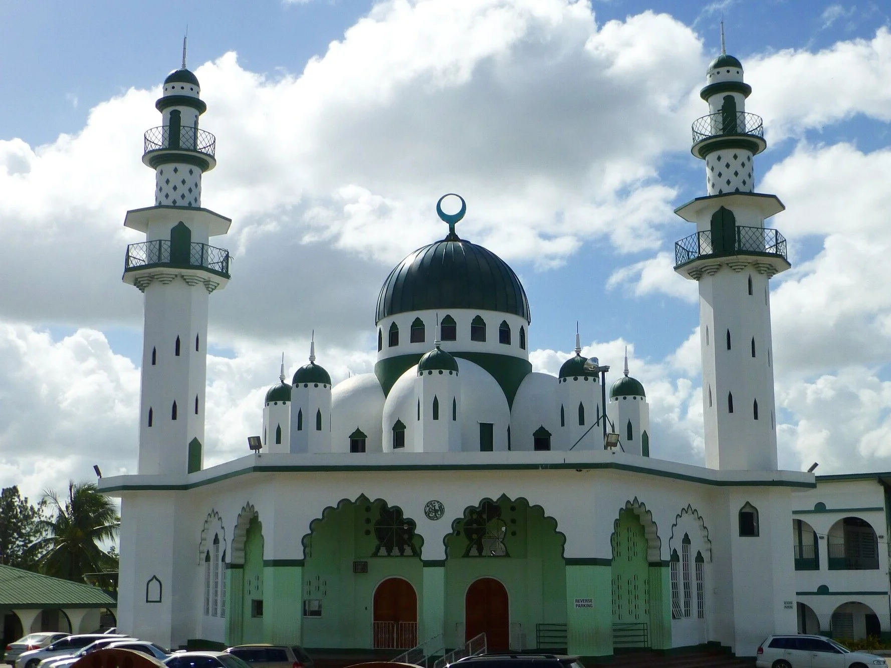 The Jinnah Memorial Mosque in St. Joseph, Trinidad, completed in 1954, has a feature rarely seen in mosque construction: a band of glass louvers between the main dome and its supporting wall. Instead of resting on solid masonry, the forty-foot dome s