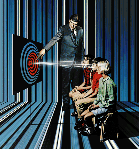A man in a suit pointing at a target on a screen with laser beams, with three children sitting in front of him, inside a room with striped blue and black walls.