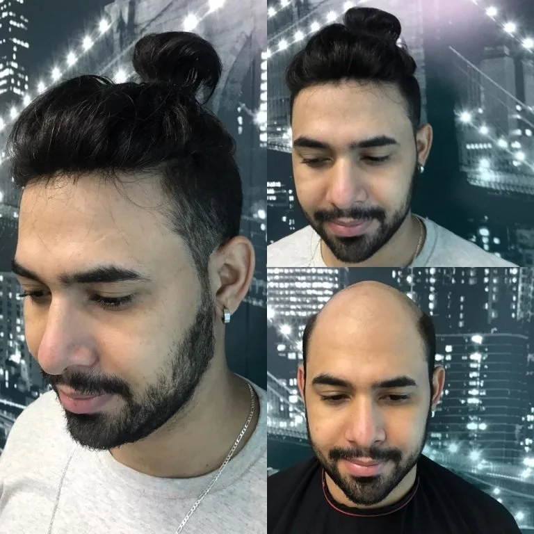 Homem com penteado com coque em fundo de cidade iluminada à noite.