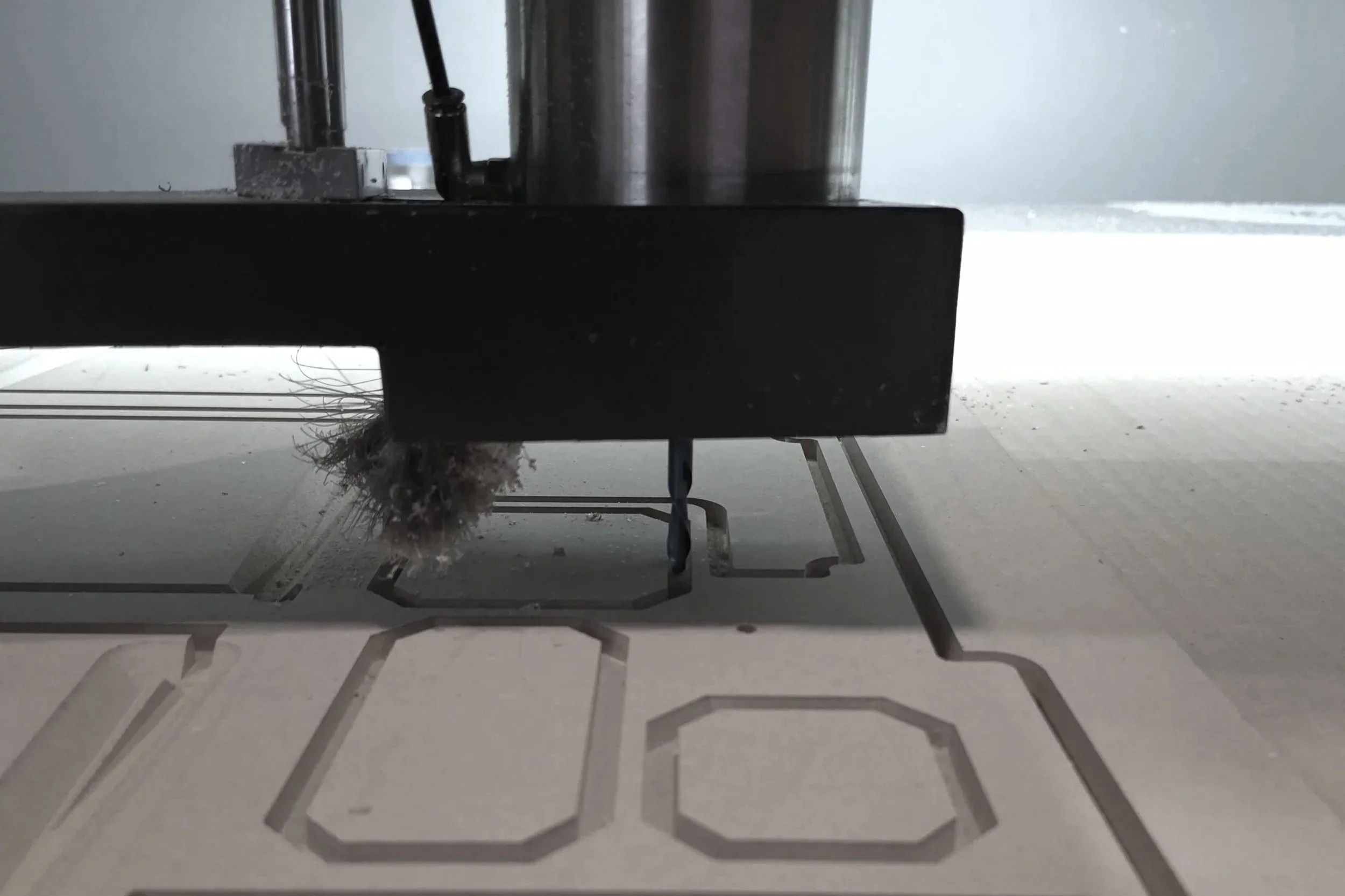 CNC machine cutting 3/8 inch MDF trim for a flight training simulator console for an aerospace client at Tempest Industries in Sarnia, Ontario.