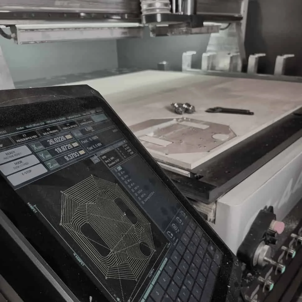 CNC controller with mounted part in the background for an oil and gas R&D prototype.
