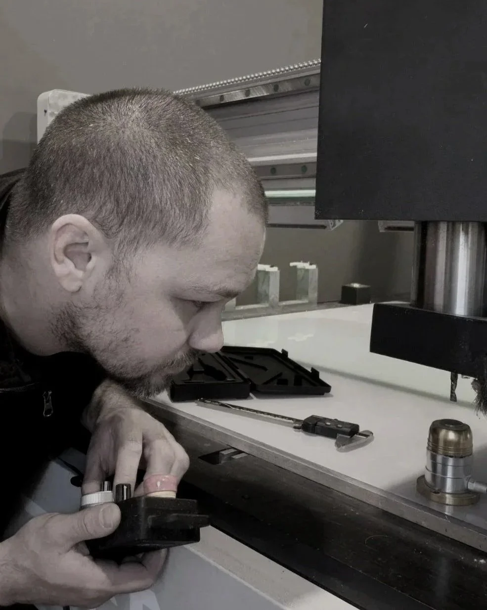 CNC operators sets a tool length with a tool touch off pad for precision manufacturing