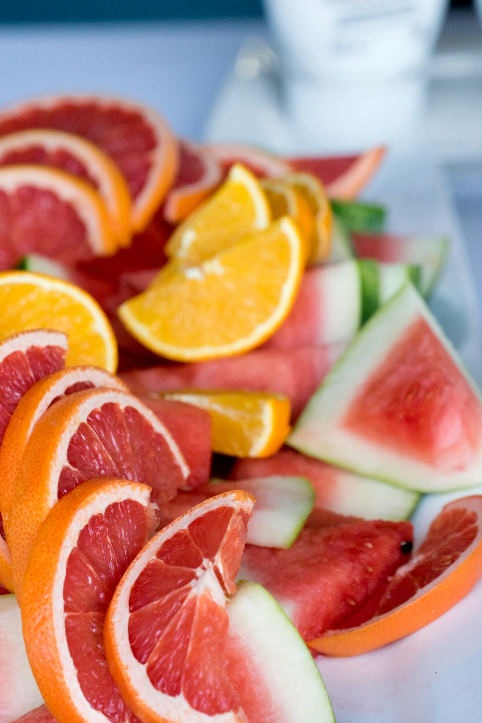 Assorted slices of citrus and melon fruit, including oranges, grapefruits, watermelons, and honeydews.