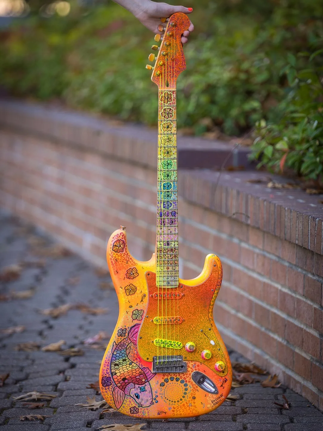 Some beautiful shots of this custom Fender Strat!🎸🧡 With hand drawn artwork by Artist Emilie Rosati ☮️ Photography credits to the talented @cheshiredave 📸#guitarphotography #fenderstratocaster #fender #customguitar #emilierosati #guitarart #koi #c