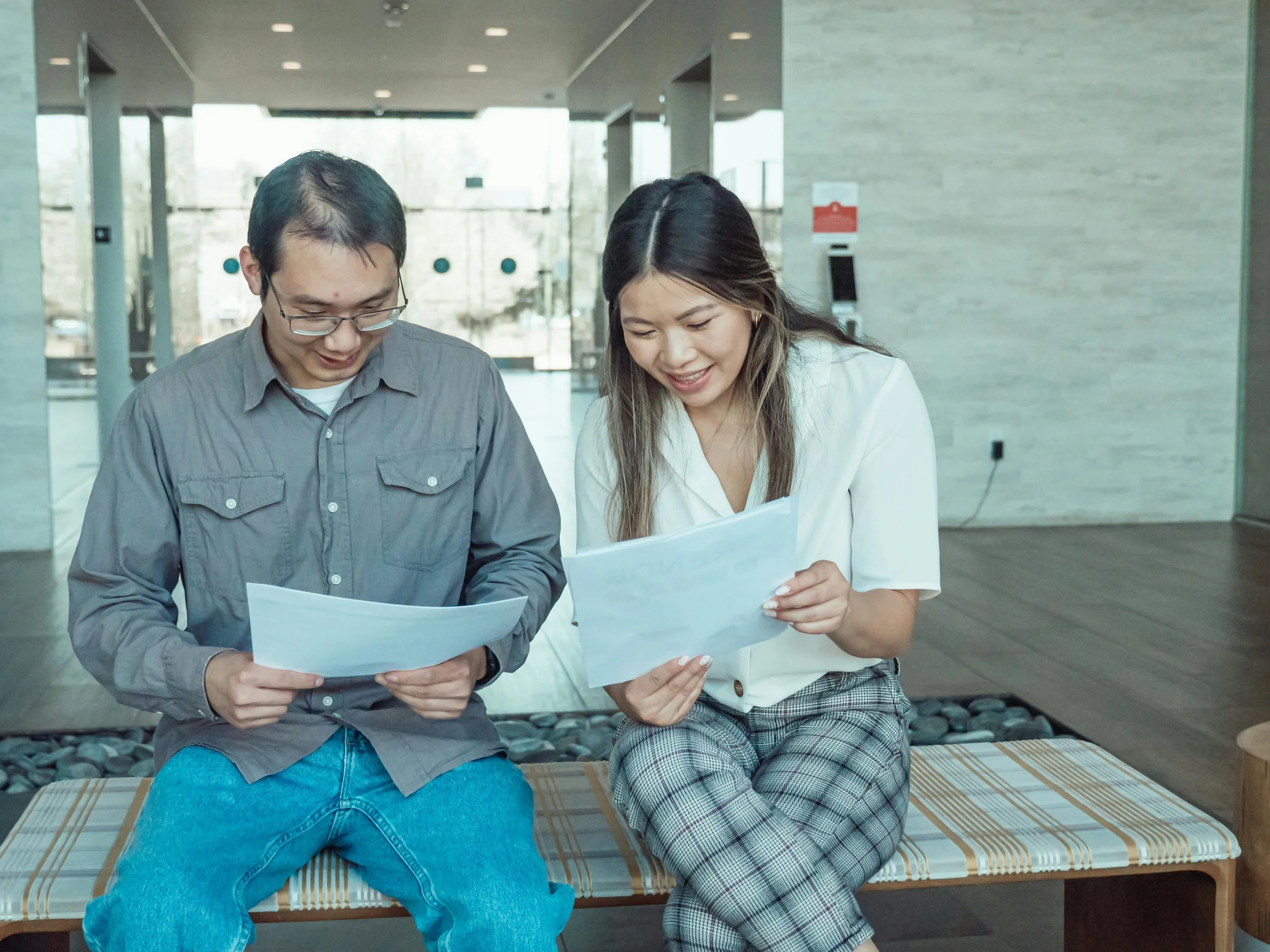 man and woman reading documents and discussing