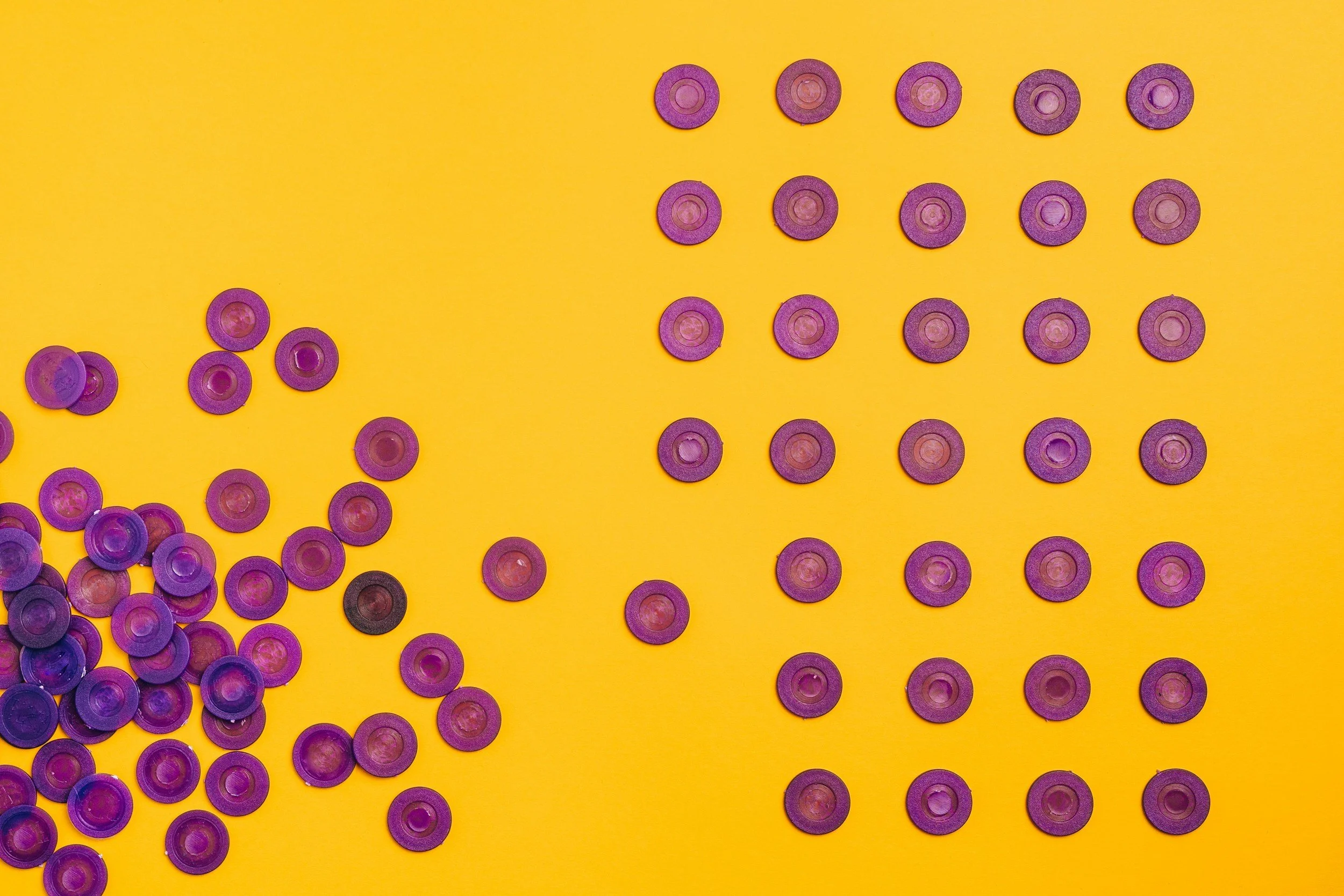 some buttons organized in lines with others in a pile