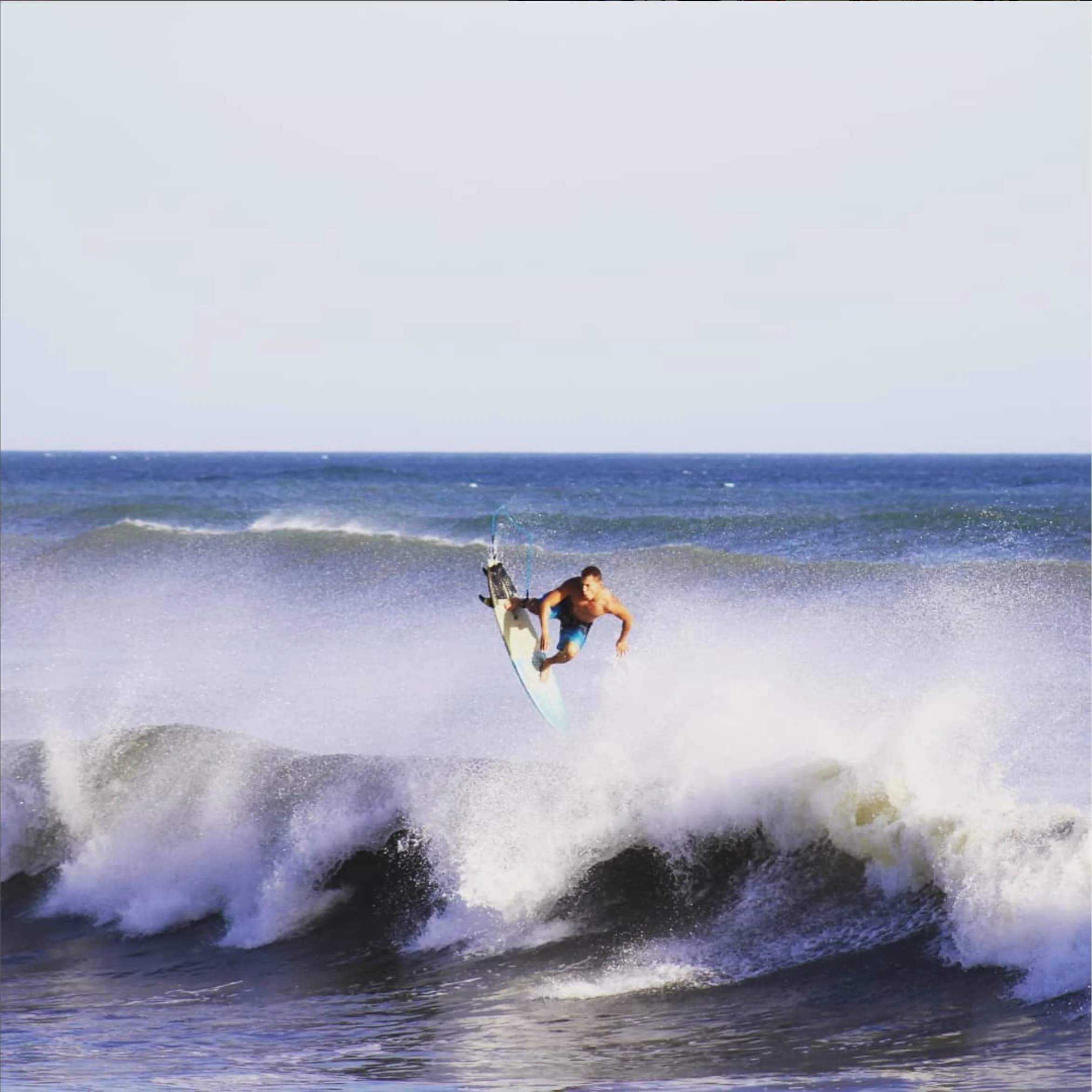 surfing at guanico beach resort