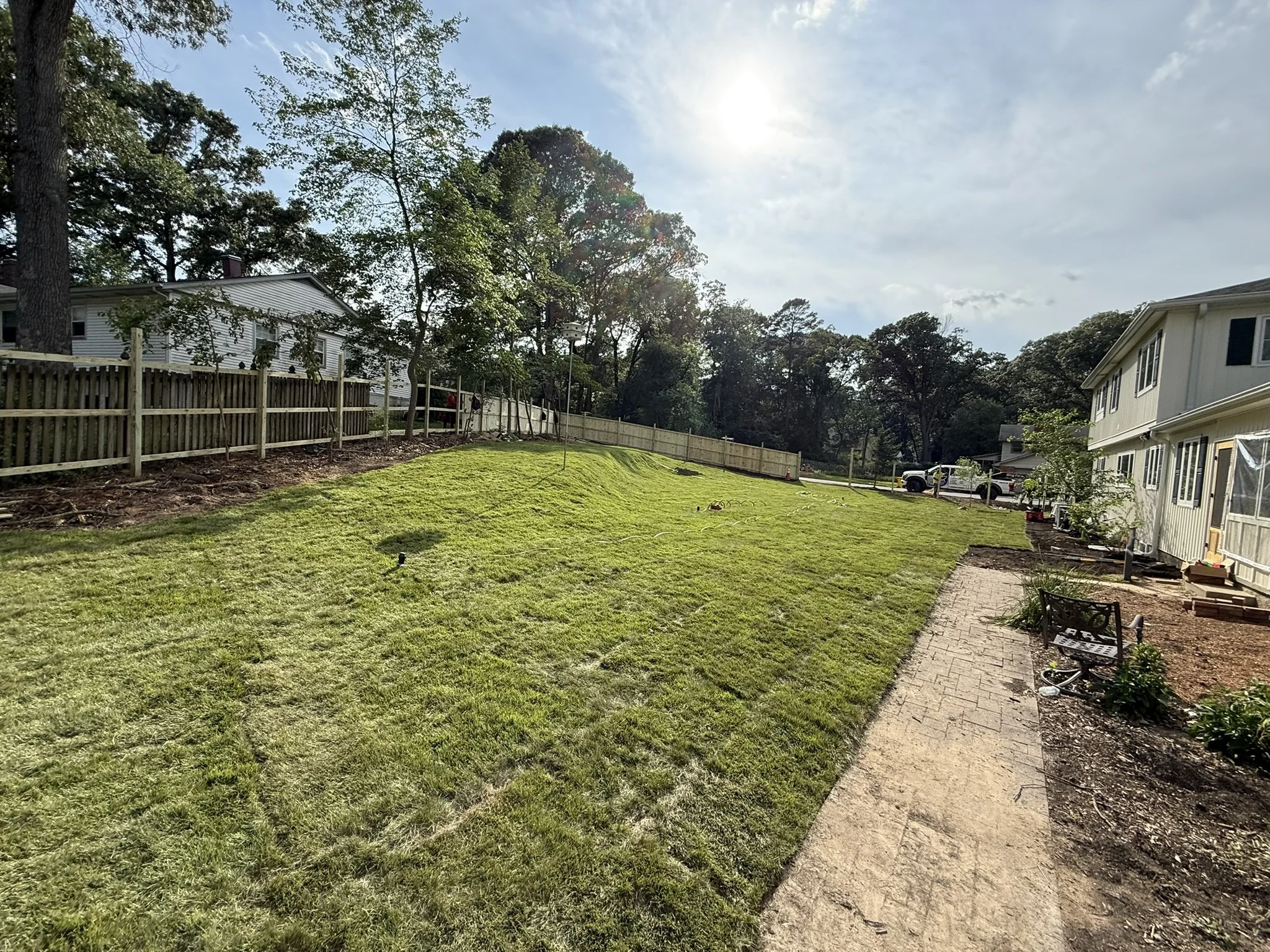 After clearing and sod placement. Fence in progress.