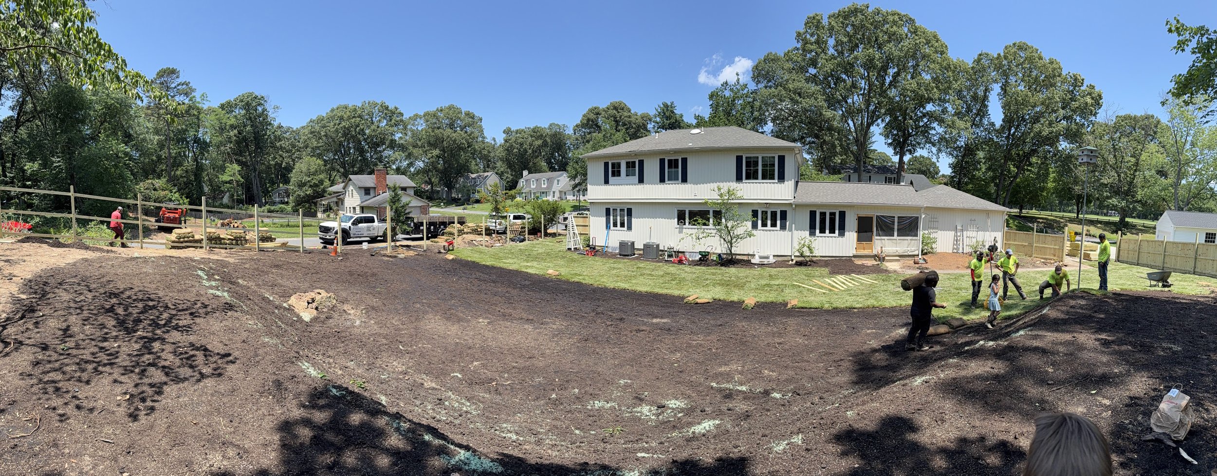 Laying of sod. Fence in progress.