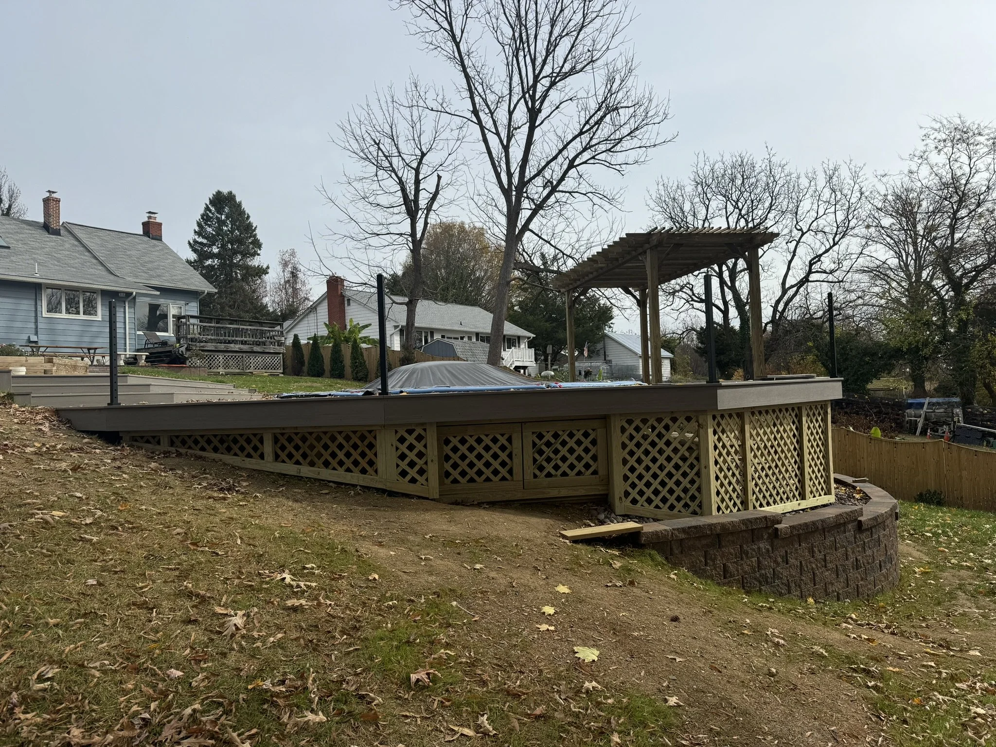 Pool Deck in Progress w/Addition of Retaining Wall & Pergola 
