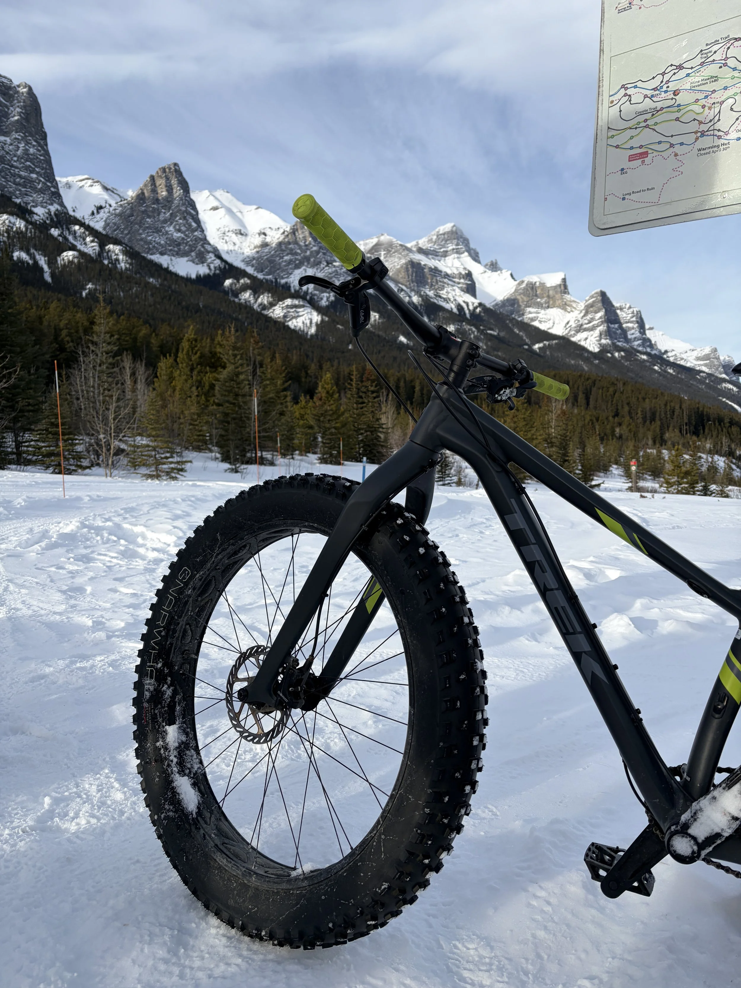 front tire of a bike profiled in front of mountains in Canmore, AB