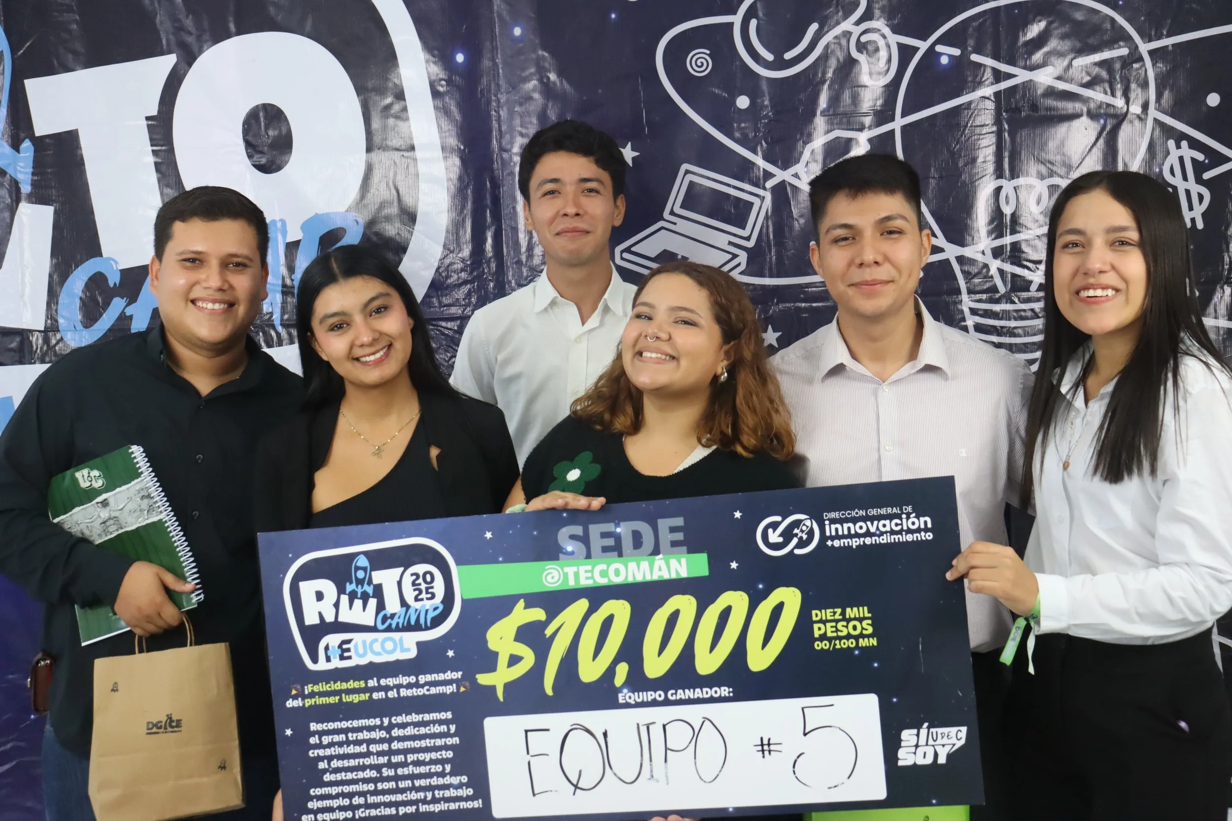 Smiling woman with long brown hair, wearing a blue top, facing the camera.