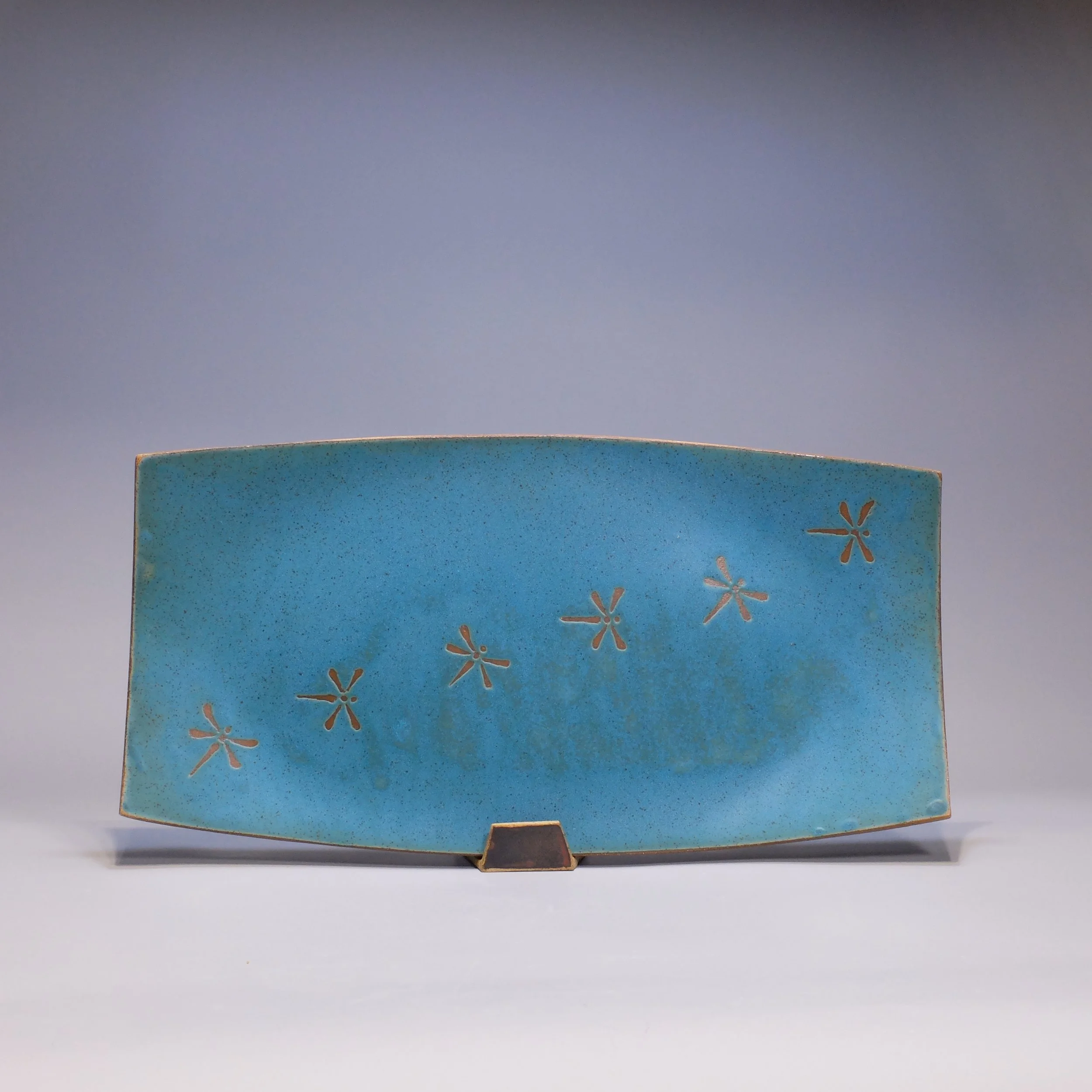 SOLD Platter, 2026. Speckled stoneware, turquoise glaze, dragonfly motif. 17.25"L, 8.75"W, 0.75"D.
