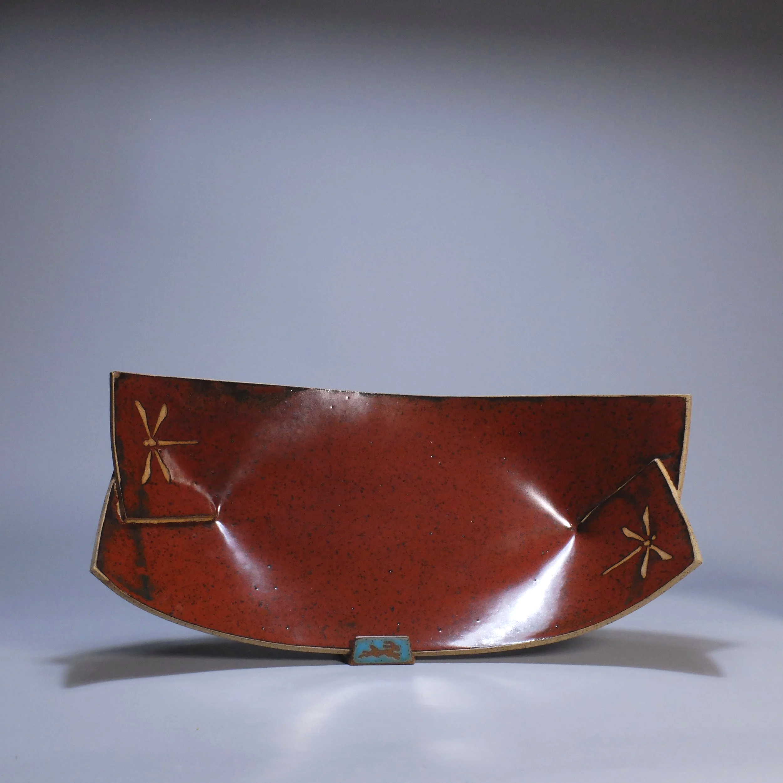 Big Boat, 2026. Speckled stoneware, red iron oxide glaze, dragonfly motif. 16.5"L, 8.5"W, 5.25"D.