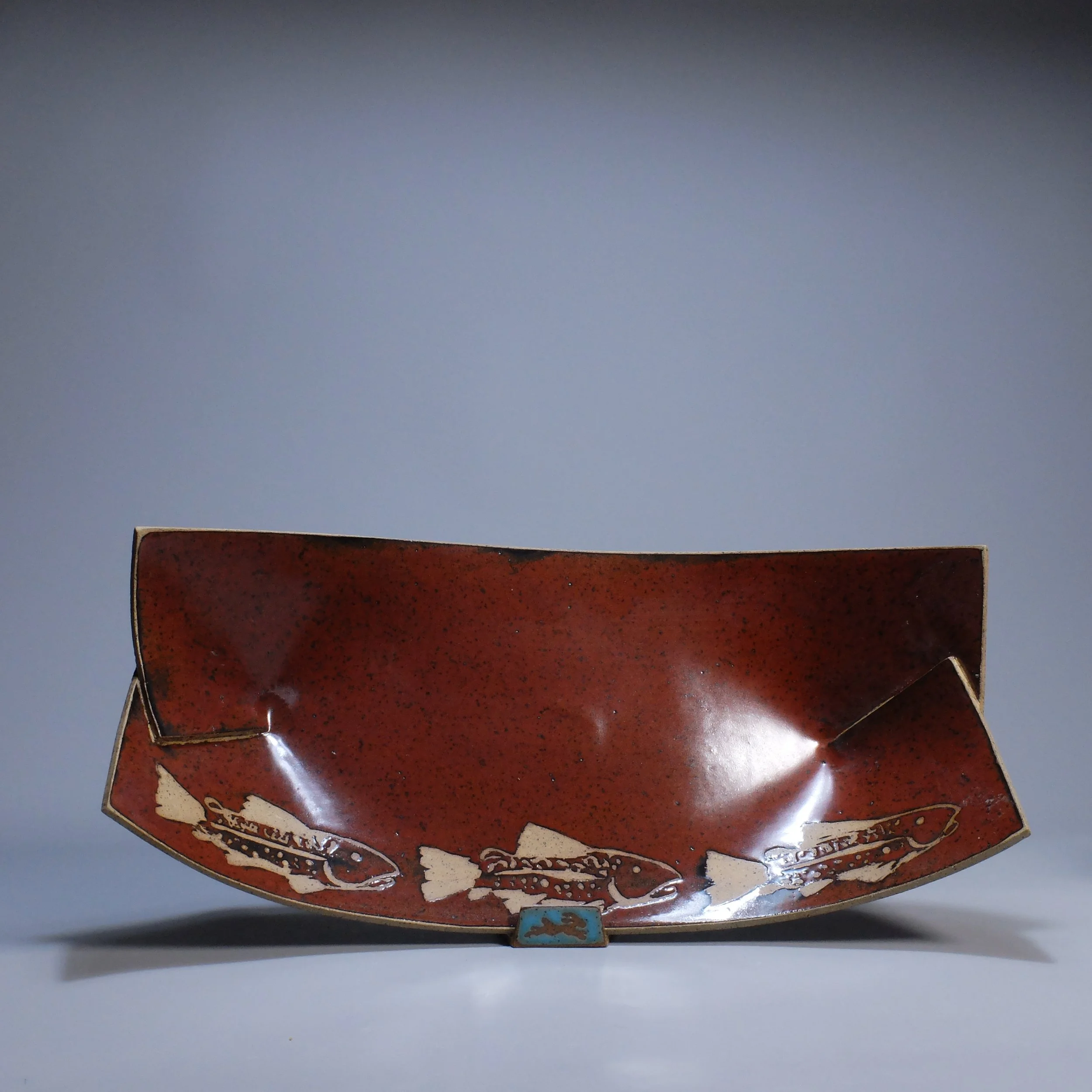 Big Boat, 2026. Speckled stoneware, red iron oxide glaze, brook trout motif. 16.5"L, 8.5"W, 5.25"D.